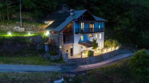 a small house with a balcony on a hill at night at Residenza Villa Paradiso in Villadossola