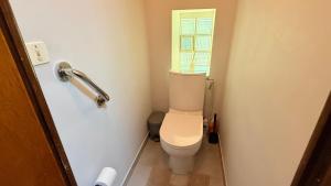 a small bathroom with a toilet with a window at Chez Aneta in Sisteron +4 photos