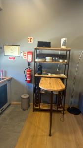 a small table in a room with a shelf at Matosinhos Urban Loft in Matosinhos