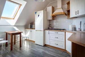 a kitchen with a white refrigerator and a table at Pokoje Oaza Spokoju in Nowęcin