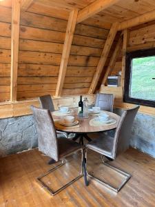 a dining room with a table and chairs in a cabin at Retreat Komovi in Andrijevica