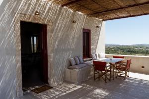a patio with a couch and a table and chairs at Kirkinezi Kythira in Kythira