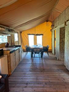 a dining room with a table and chairs in a tent at Gîte les 7 saveurs in Cucugnan