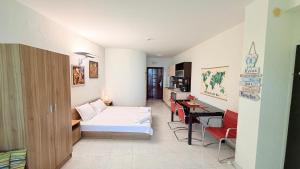 a room with a bed and a desk in it at Плажни Апартаменти Силвър Бийч - Silver Beach Sea Apartments in Byala +93 photos
