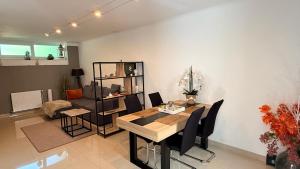 a living room with a dining room table and a couch at Chez Aneta in Sisteron