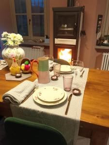 a table with a green and white table cloth on it at MaVa' Country House in Castelnuovo Bocca dʼAdda +16 photos