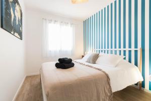 a bedroom with a bed with a black towel on it at Maison Lafitte-Vigordane in Lafitte-Vigordanne