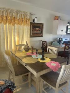 a dining room table with chairs and a dining room at Pleasant 1 bed room in Discovery Bay