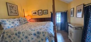 a bedroom with a bed with a blue and white bedspread at Niagara Historic Inn in Lockport