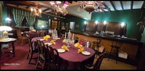a dining room with a table with a purple table cloth at Niagara Historic Inn in Lockport