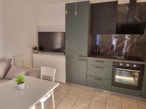a kitchen with a couch and a table in a room at Apartmani Vesna in Vir