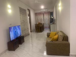 a living room with a couch and a flat screen tv at Airport Transit Home in Ja-Ela +7 photos