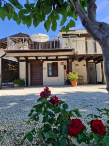 a house with red roses in front of it at La Dolce Vita in Castelfidardo