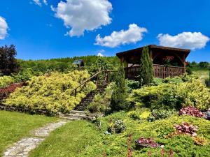 a garden with stairs leading up to a gazebo at Orlikowe Wzgórze in Rabe