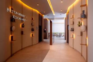 a corridor of a building with lights on the walls at Suites By Le Rêve in Tangier