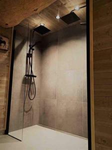 a shower in a room with a wall at Ørnereiret in Torvetjørn +57 photos