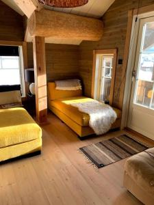 a bedroom with two beds in a wooden room at Ørnereiret in Torvetjørn