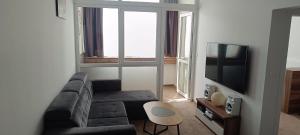 a living room with a couch and a tv at Tami Apartman Hviezdoslavova 2, Liptovsky Mikulas, Private Parking in Liptovský Mikuláš