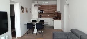 a kitchen with a table and chairs in a room at Tami Apartman Hviezdoslavova 2, Liptovsky Mikulas, Private Parking in Liptovský Mikuláš