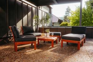 a patio with two chairs and a table and two chairs at Black Forest Living am Marktplatz in Freudenstadt