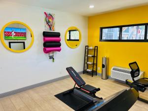 a gym with two exercise bikes and a wall with mirrors at Nova Inn Resort in Boynton Beach