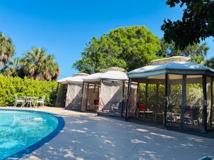 a group of tents with a swimming pool at Nova Inn Resort in Boynton Beach