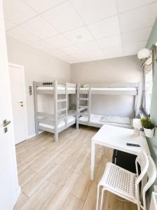 a room with a desk and chairs and bunk beds at Hostel Filip 2 in Gdańsk