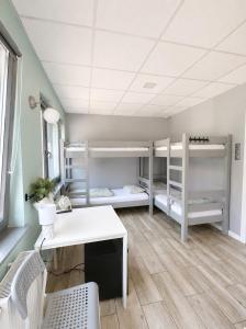 a room with three bunk beds and a desk at Hostel Filip 2 in Gdańsk +69 photos