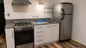 a kitchen with a stove and a refrigerator at Rental Tigre in Tigre
