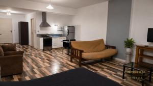 a living room with a couch a chair and a kitchen at Rental Tigre in Tigre