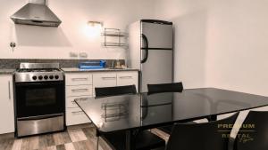a kitchen with a stainless steel refrigerator and a table at Rental Tigre in Tigre