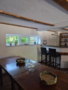 a dining room with a wooden table and chairs at Kuća za odmor Skela in Glina