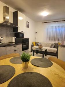 a kitchen and a living room with a table at Kuća za odmor Skela in Glina +21 photos