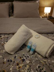 a bed with two towels and two thermometers on it at Kuća za odmor Skela in Glina