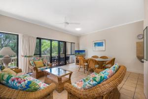 a living room with a couch and chairs and a table at Mirra Chana Beachfront Apartments Mooloolaba in Mooloolaba