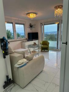 a living room with a couch and a table at Irma Haus in Jadranovo
