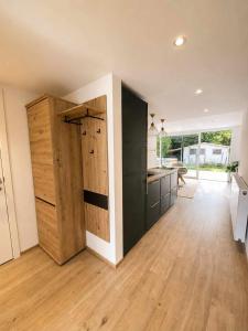 a large room with a wooden door in a kitchen at Le Cocon, Jacuzzi privé Spa Francorchamps in Spa