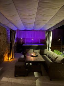 a living room with a couch and a table at Dalmatian Stone House Angela in Drniš