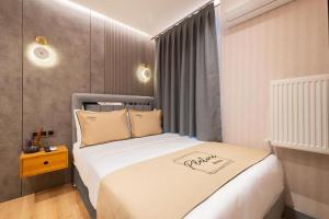 a bedroom with a bed in a room with a window at Platine Plus Suite in Istanbul