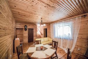 a dining room with a table and a couch at Всім бобра in Pulʼmo