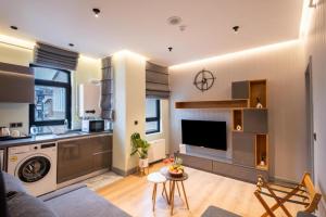 a living room with a couch and a kitchen at Platine Plus Suite in Istanbul