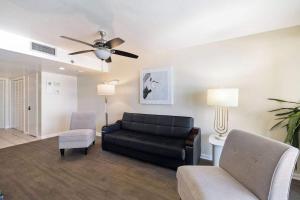 a living room with a couch and a chair at Beachfront Paradise at Phoenix II 2046 in Orange Beach