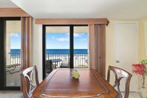 a dining room with a table and a view of the ocean at Beachfront Paradise at Phoenix II 2046 in Orange Beach