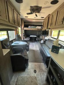 a living room with couches and a table in an rv at Waxberry Trailer by Kings Canyon and Sequoia National Parks in Squaw Valley