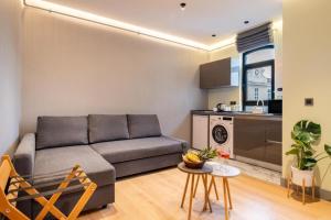 a living room with a couch and a kitchen at Platine Plus Suite in Istanbul +26 photos