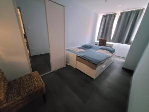 a bedroom with a bed and a mirror and a chair at Magic Downtown Szeged in Szeged