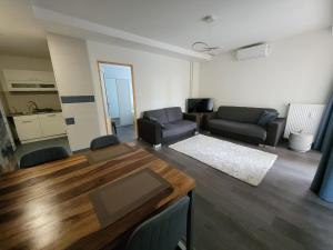 a living room with a couch and a table at Magic Downtown Szeged in Szeged +8 photos