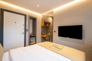 a bedroom with a bed and a flat screen tv at Platine Plus Suite in Istanbul