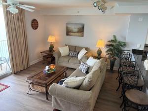 a living room with a couch and a table at Oceanfront Condo with Shared Pool Hot Tub & Gym in Panama City Beach