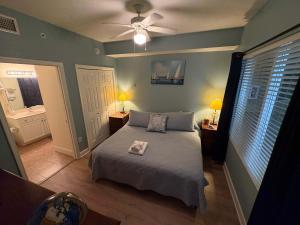 a bedroom with a bed and a ceiling fan at Oceanfront Condo with Shared Pool Hot Tub & Gym in Panama City Beach